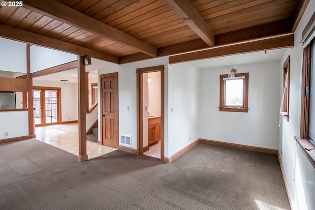 unfurnished room with light colored carpet, french doors, wood ceiling, and beamed ceiling