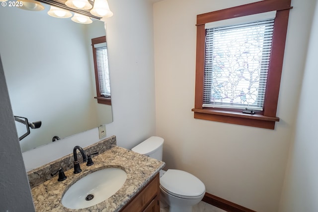 bathroom featuring toilet and vanity