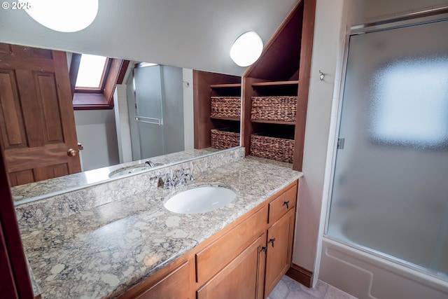 bathroom featuring enclosed tub / shower combo and vanity