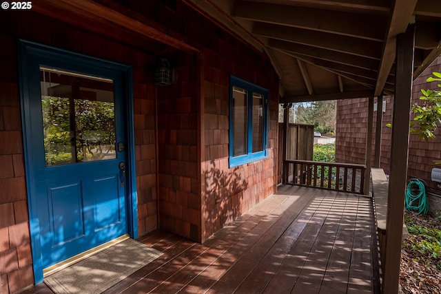 view of exterior entry featuring a wooden deck