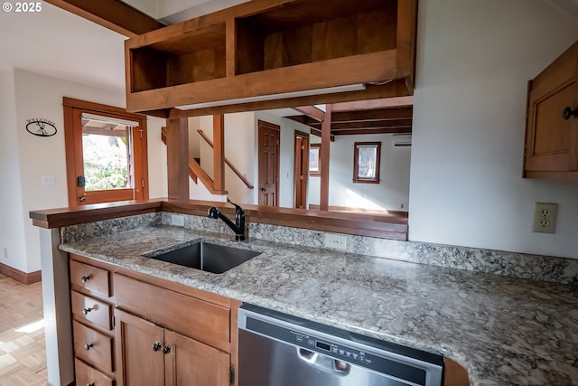 kitchen featuring light parquet floors, stainless steel dishwasher, light stone countertops, beam ceiling, and sink