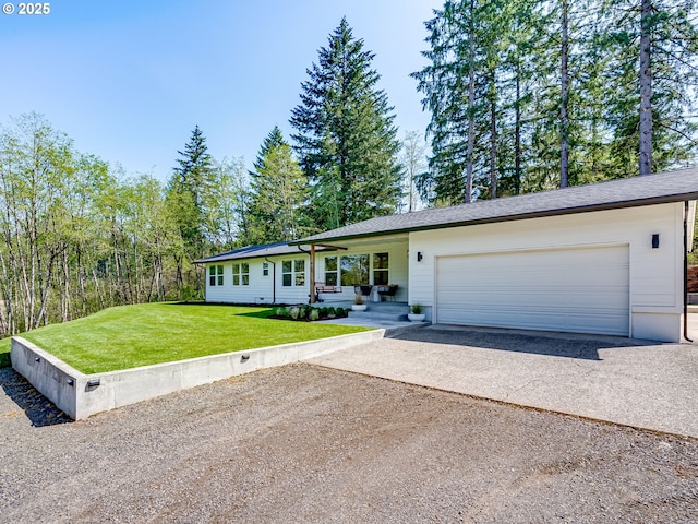 ranch-style house with a garage, a front lawn, and aphalt driveway