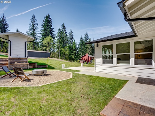 view of yard featuring a patio and a fire pit
