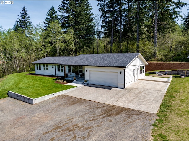 ranch-style house with an attached garage, a shingled roof, driveway, and a front yard