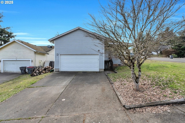 view of home's exterior featuring a detached garage and a lawn