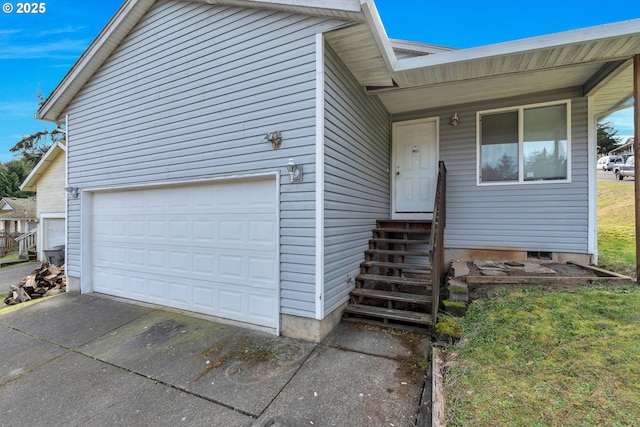 view of front of home with a garage, entry steps, and driveway