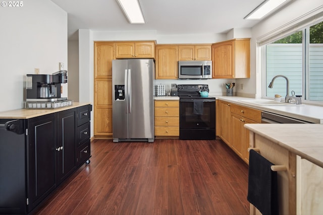 13142 SW 17th St, Beaverton, OR 97008 - kitchen featuring appliances with stainless steel finishes, dark wood-style flooring, a sink, light countertops, and dark cabinetry