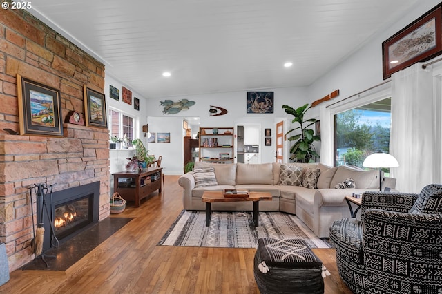 living area featuring plenty of natural light, a fireplace, and wood finished floors