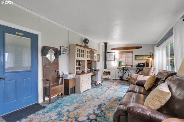 living room with carpet floors, a wood stove, and crown molding