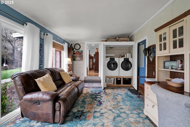 living room featuring washing machine and dryer and crown molding