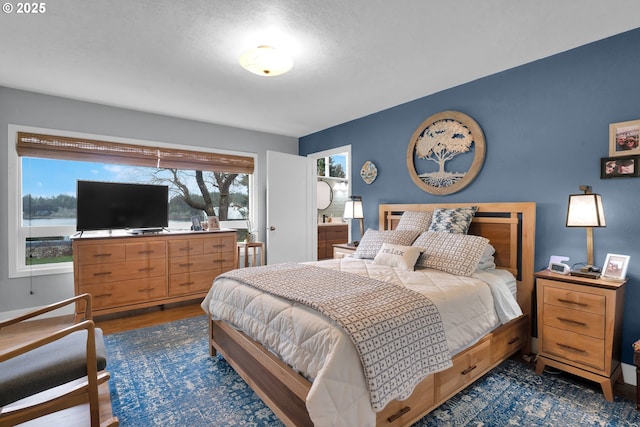 bedroom with dark wood-style floors