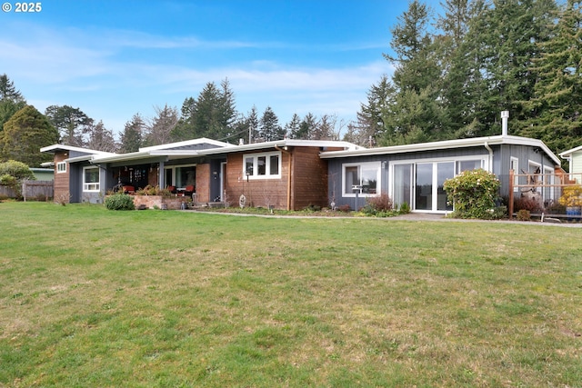 single story home with a front yard and fence