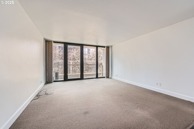 255 SW Harrison St Unit 3C, Portland, OR 97201 - carpeted spare room with baseboards and expansive windows