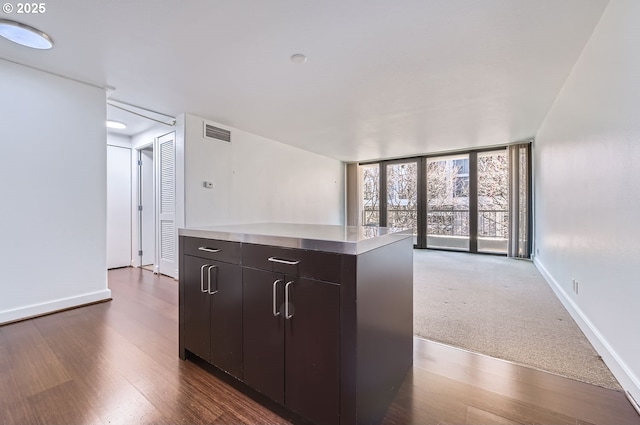255 SW Harrison St Unit 3C, Portland, OR 97201 - kitchen featuring light countertops, dark wood-style floors, baseboards, and modern cabinets