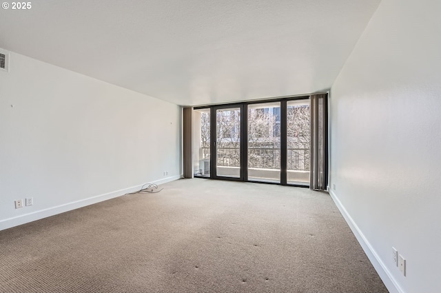 255 SW Harrison St Unit 3C, Portland, OR 97201 - unfurnished room featuring baseboards, carpet flooring, and floor to ceiling windows