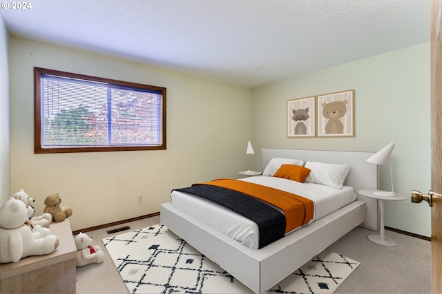 bedroom featuring light colored carpet, baseboards, and visible vents