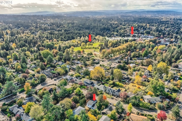 bird's eye view with a wooded view