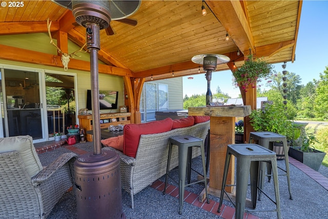 view of patio featuring a bar and ceiling fan