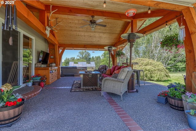 view of patio featuring a jacuzzi, ceiling fan, and an outdoor kitchen