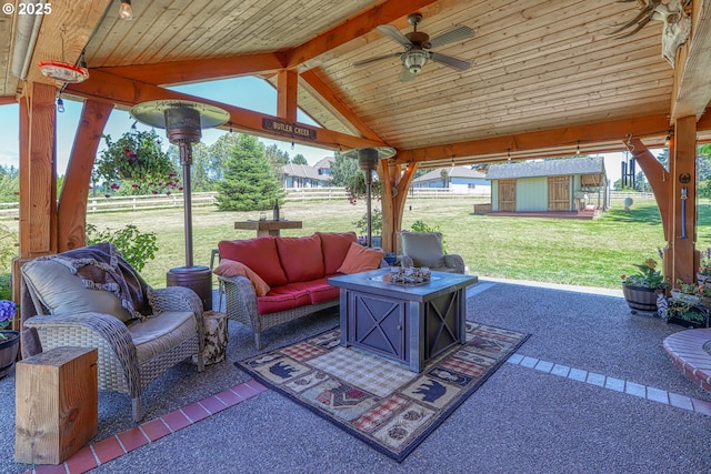 view of patio / terrace with a storage shed, a gazebo, outdoor lounge area, and ceiling fan