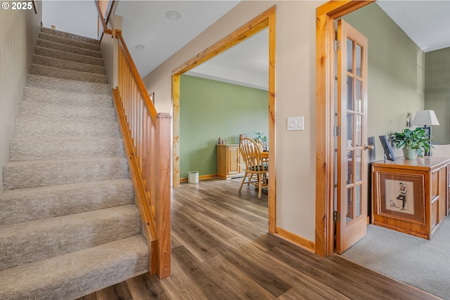 staircase with french doors and wood-type flooring