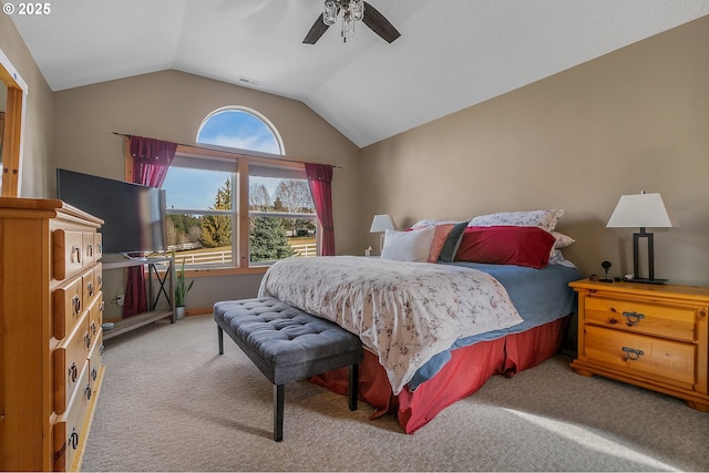 bedroom with vaulted ceiling, light colored carpet, and ceiling fan