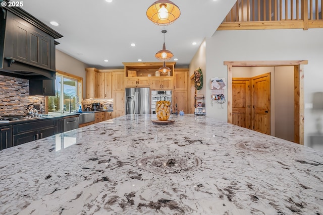 kitchen featuring sink, hanging light fixtures, stainless steel appliances, decorative backsplash, and light brown cabinets