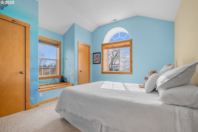 bedroom featuring vaulted ceiling and carpet flooring