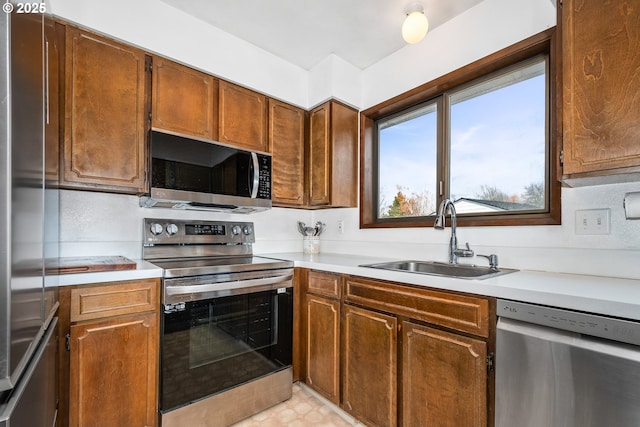 kitchen with sink and appliances with stainless steel finishes