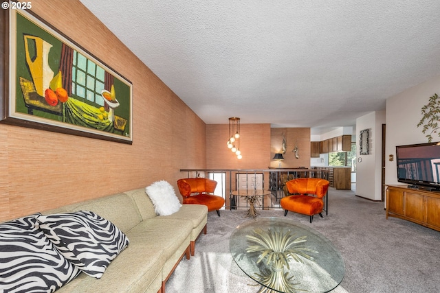 carpeted living room featuring a textured ceiling