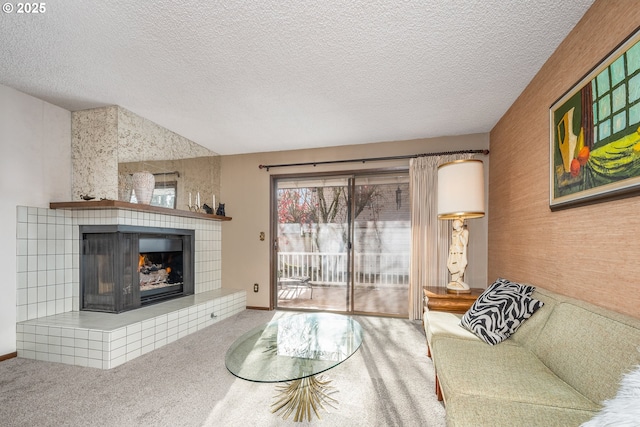 carpeted living room with a textured ceiling and a tiled fireplace