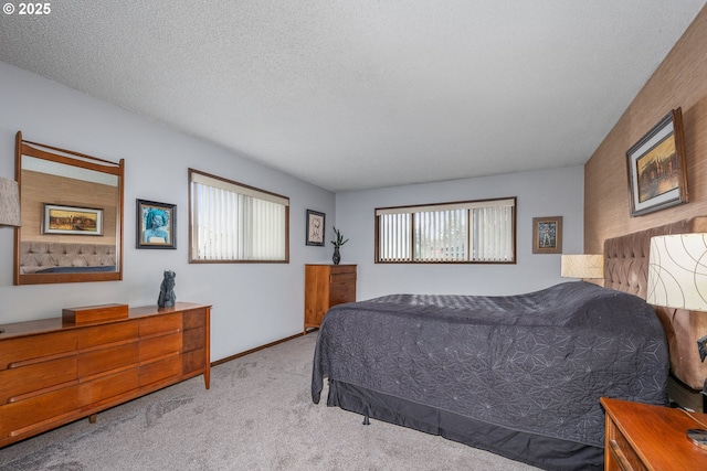 bedroom featuring light colored carpet and a textured ceiling