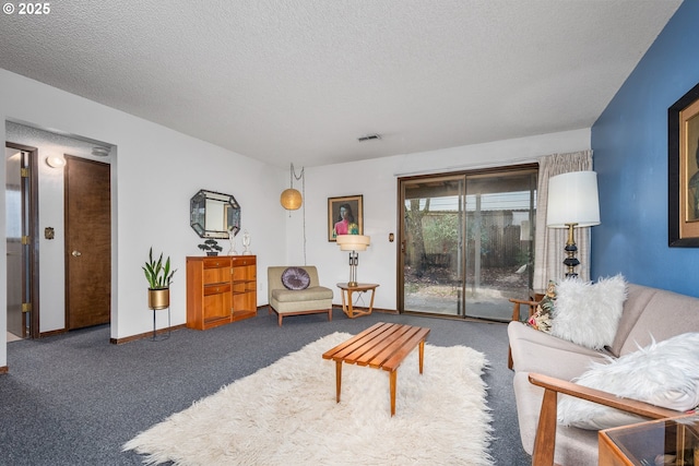 carpeted living room featuring a textured ceiling