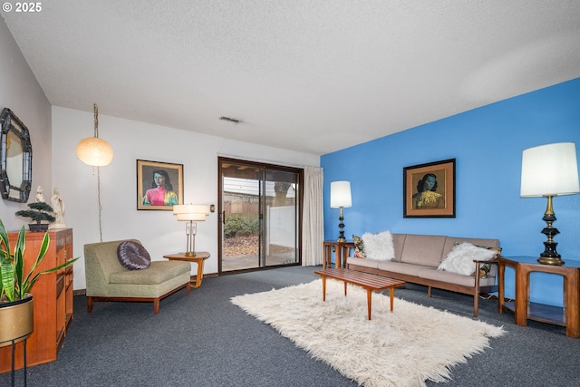 carpeted living room featuring a textured ceiling