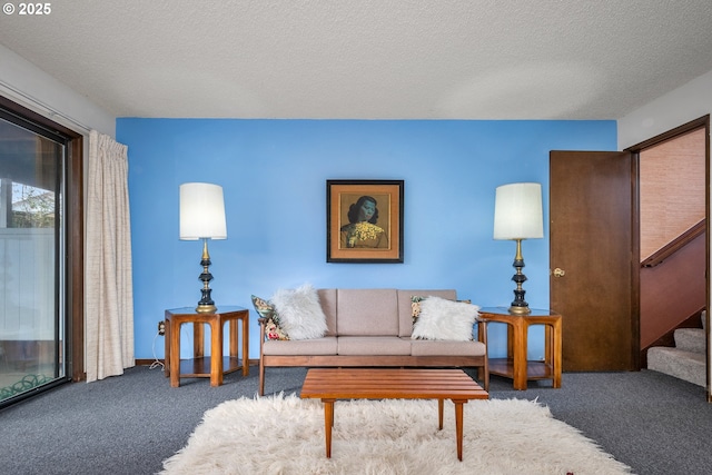 living room featuring carpet flooring and a textured ceiling