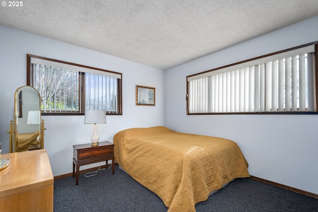 bedroom featuring dark carpet and a textured ceiling