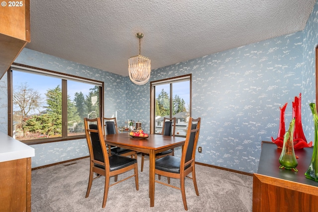 dining area featuring a chandelier and light colored carpet