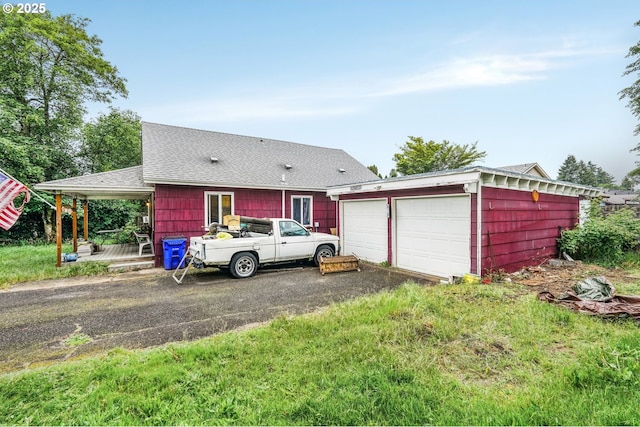 2758 SE 170th Ave, Portland, OR 97236 - view of front of home featuring an outdoor structure, roof with shingles, and a wooden deck