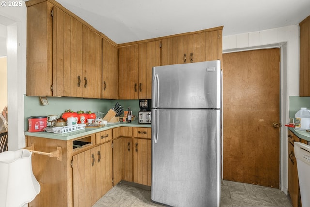 2758 SE 170th Ave, Portland, OR 97236 - kitchen featuring freestanding refrigerator, light countertops, dishwasher, and brown cabinetry