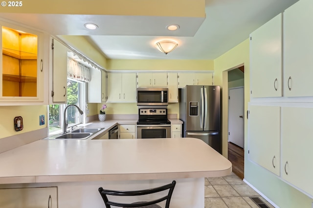 173 NE 32nd Ave, Hillsboro, OR 97124 - kitchen with appliances with stainless steel finishes, a sink, light countertops, a peninsula, and recessed lighting