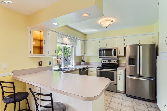 173 NE 32nd Ave, Hillsboro, OR 97124 - kitchen with stainless steel appliances, a peninsula, a sink, light countertops, and recessed lighting