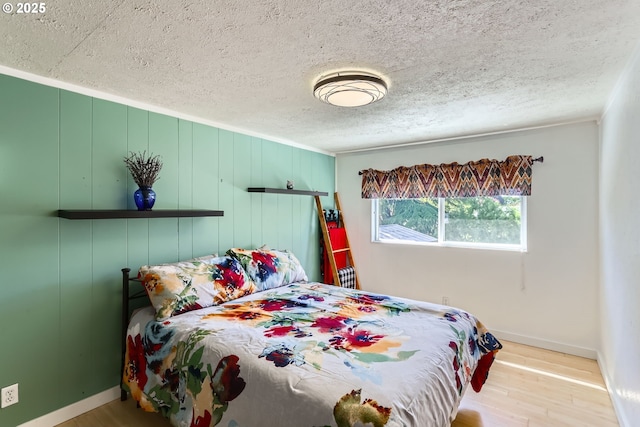173 NE 32nd Ave, Hillsboro, OR 97124 - bedroom with baseboards, wood finished floors, and a textured ceiling