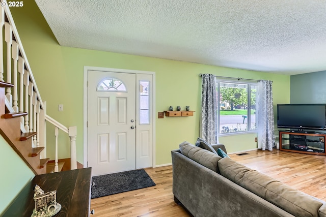 173 NE 32nd Ave, Hillsboro, OR 97124 - foyer featuring wood finished floors, a textured ceiling, stairs, and baseboards
