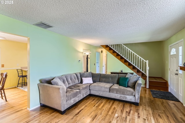 173 NE 32nd Ave, Hillsboro, OR 97124 - living area featuring stairway, a textured ceiling, and wood finished floors