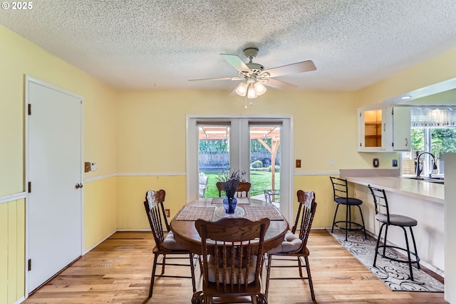 173 NE 32nd Ave, Hillsboro, OR 97124 - dining area with french doors, a textured ceiling, light wood-style flooring, and ceiling fan