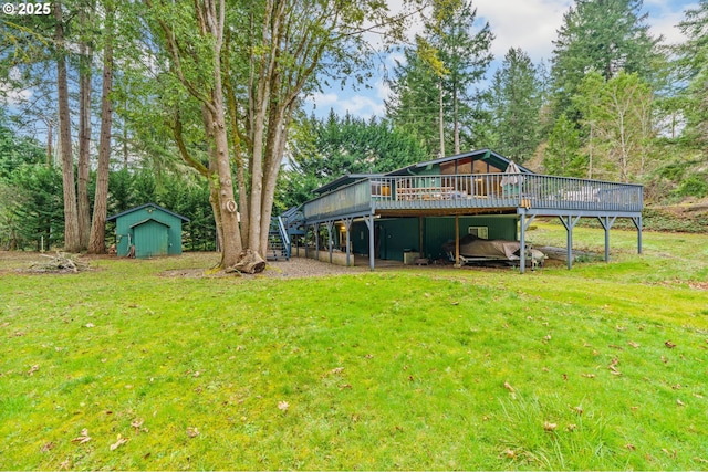 view of yard featuring a wooden deck and a shed