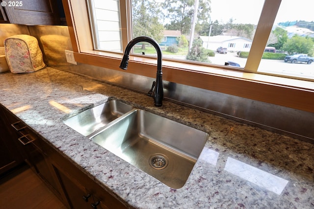 room details with stone countertops and a sink