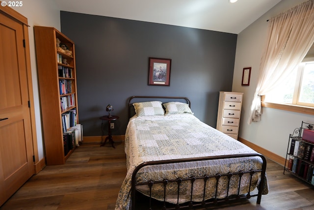 bedroom featuring baseboards and wood finished floors