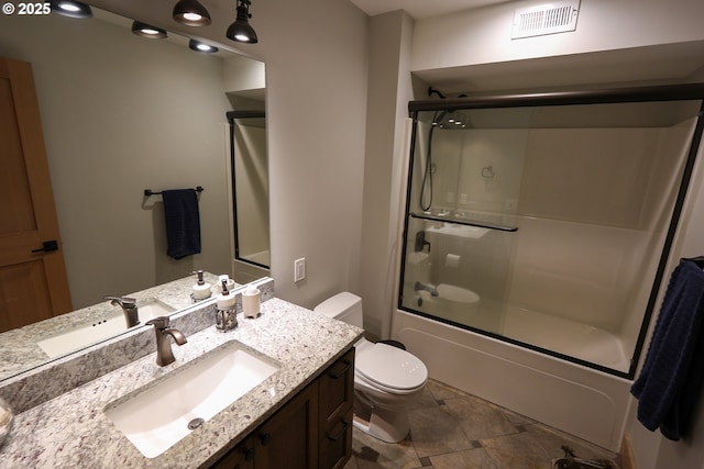 full bath featuring toilet, combined bath / shower with glass door, vanity, and visible vents