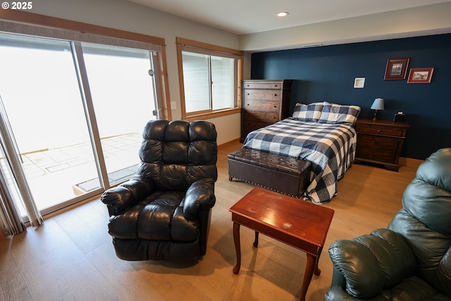 bedroom featuring access to exterior, multiple windows, wood finished floors, and recessed lighting